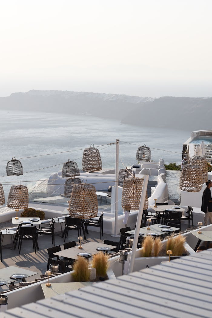 gallery-03 Elegant outdoor dining experience overlooking the Aegean Sea in Fira, Greece. Perfect for travel enthusiasts.